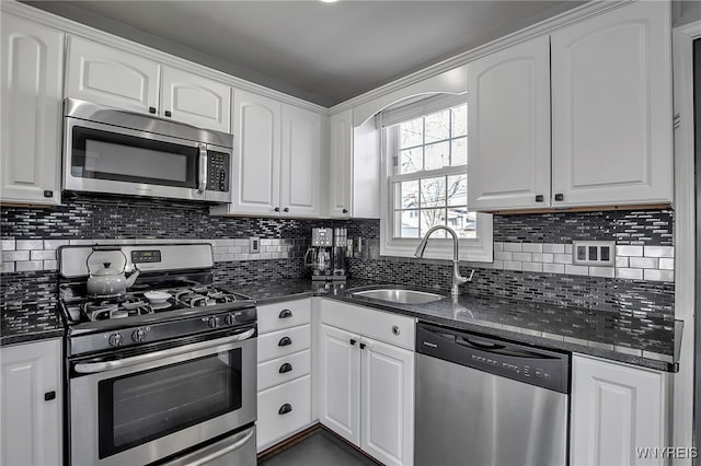 kitchen featuring a sink, appliances with stainless steel finishes, and white cabinetry