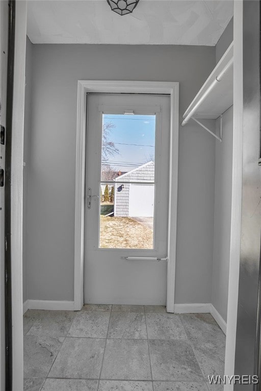 doorway to outside featuring baseboards