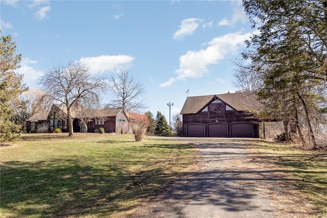 exterior space with an outbuilding, a barn, a garage, and dirt driveway