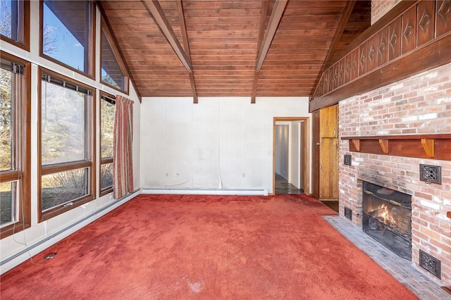 unfurnished living room with beamed ceiling, a baseboard heating unit, carpet floors, a fireplace, and wood ceiling