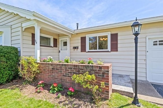 view of exterior entry with an attached garage