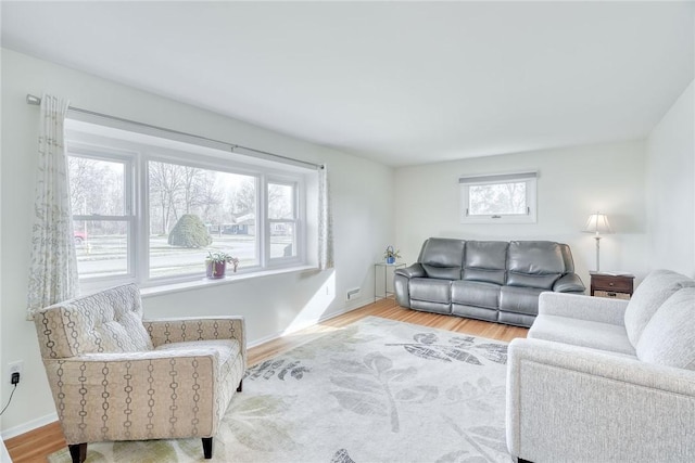 living room with baseboards, plenty of natural light, and wood finished floors