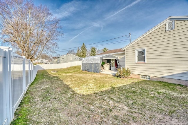 view of yard with an outbuilding and a fenced backyard