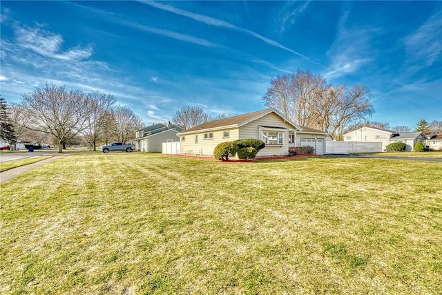 view of front of house with a front yard and fence