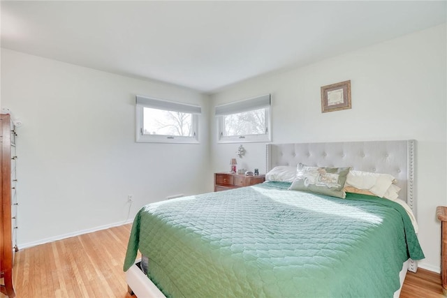 bedroom with baseboards and light wood-type flooring