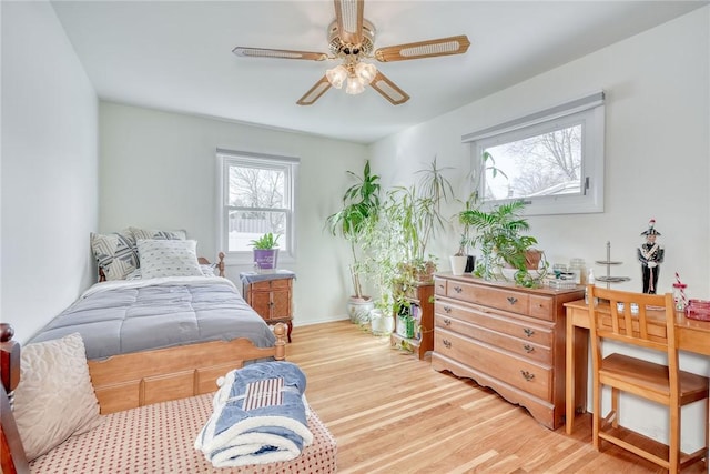 bedroom with baseboards and light wood finished floors