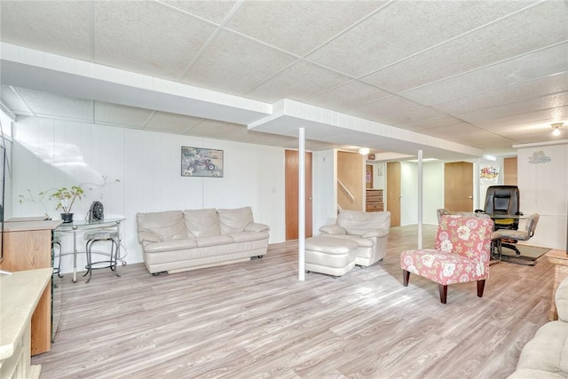 living room featuring stairway and light wood-style floors