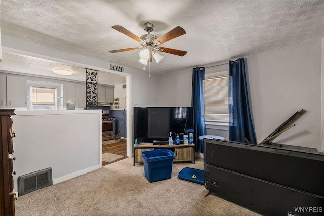 interior space featuring visible vents, a textured ceiling, connected bathroom, and a ceiling fan