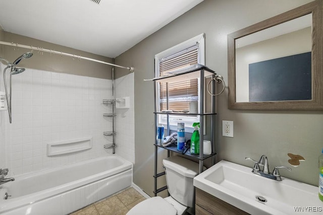 bathroom with toilet, vanity, and  shower combination