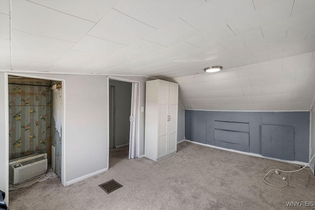 bonus room with vaulted ceiling, visible vents, a wall mounted air conditioner, and light carpet