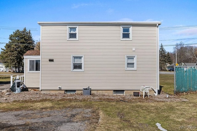 view of property exterior with a yard