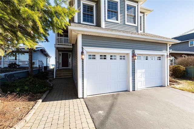 traditional-style house with aphalt driveway and an attached garage