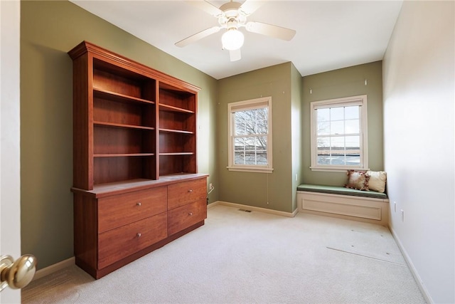 interior space with visible vents, baseboards, and light colored carpet