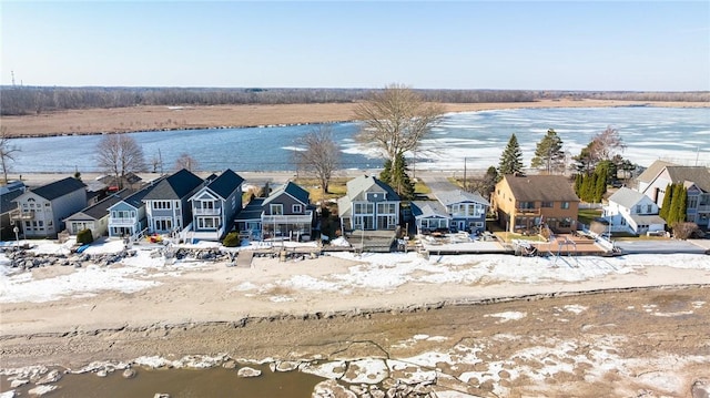 drone / aerial view with a residential view and a water view