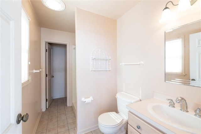 bathroom with baseboards, toilet, vanity, and tile patterned flooring