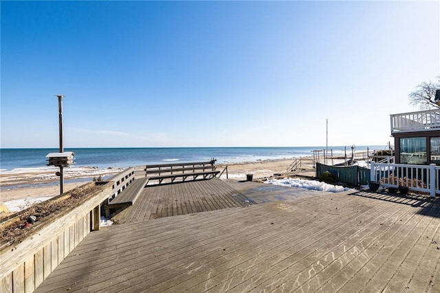 exterior space featuring a water view and a beach view