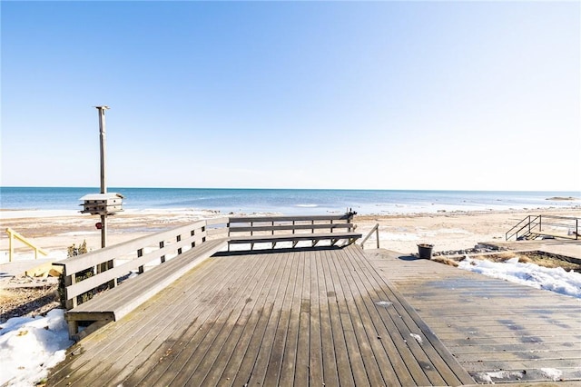 dock area with a water view and a view of the beach