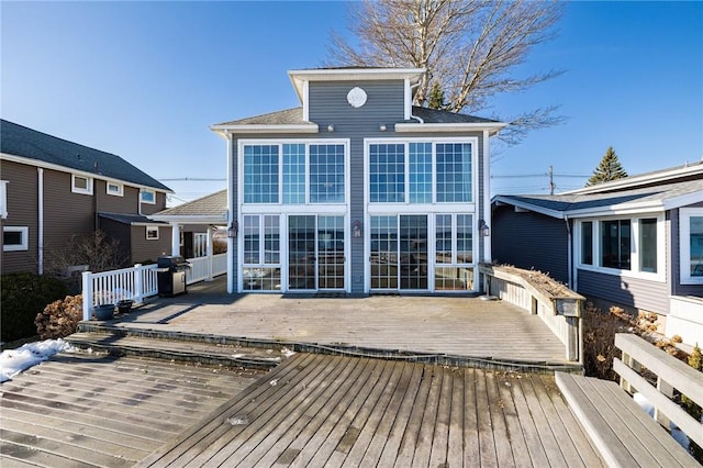 back of house featuring a wooden deck