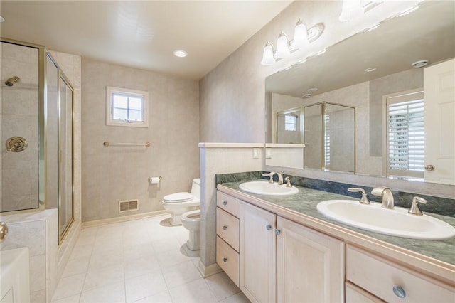 full bathroom featuring toilet, a bidet, visible vents, and a sink