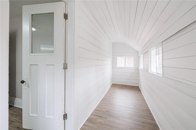 hall with wood ceiling, wood finished floors, and vaulted ceiling