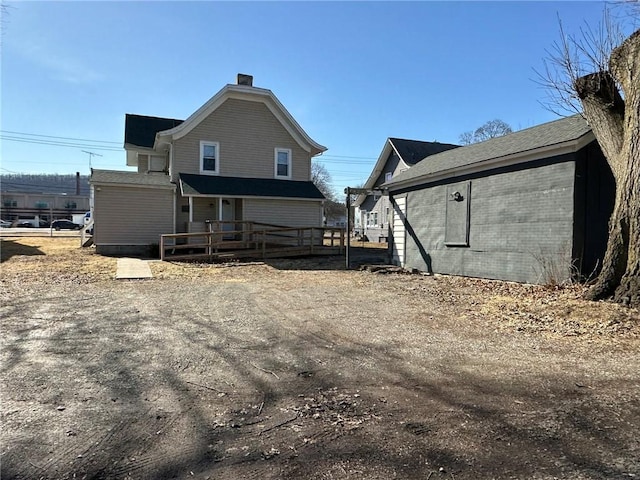 rear view of property with brick siding