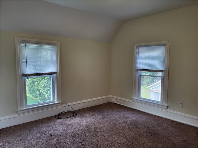 bonus room featuring vaulted ceiling, a wealth of natural light, and dark carpet