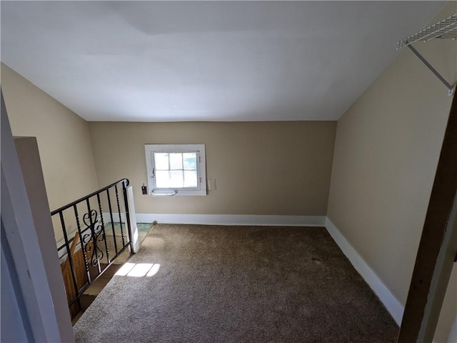 additional living space featuring carpet flooring and baseboards