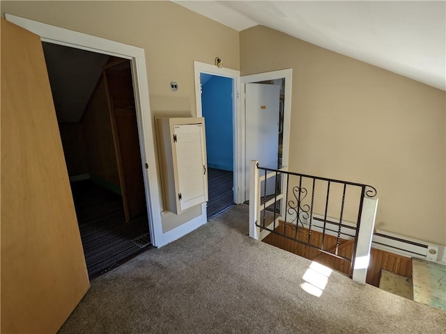 additional living space featuring carpet floors, a baseboard heating unit, and vaulted ceiling