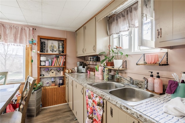 kitchen featuring a sink, light wood-style floors, cream cabinets, and light countertops