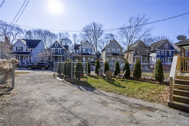 view of street featuring a residential view and a gate