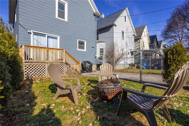 back of house featuring a fire pit and fence