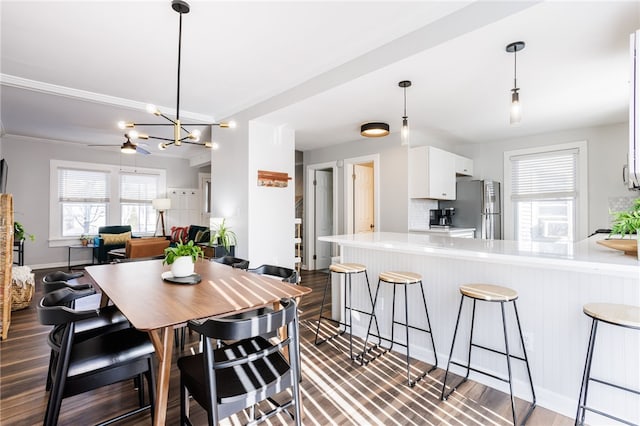 dining space featuring baseboards and dark wood-style flooring