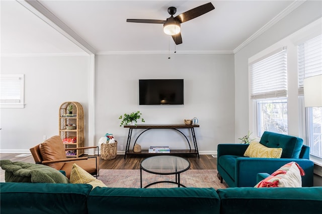 living room with wood finished floors, a ceiling fan, baseboards, and ornamental molding