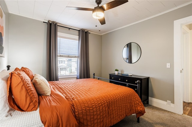 bedroom featuring a ceiling fan, baseboards, carpet floors, and ornamental molding