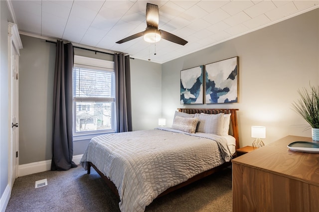 bedroom with carpet flooring, visible vents, crown molding, and baseboards