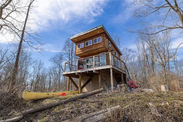 back of property featuring a wooden deck