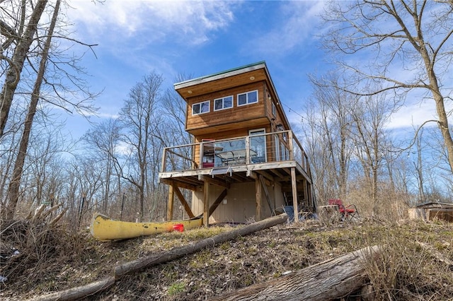 rear view of property with a wooden deck