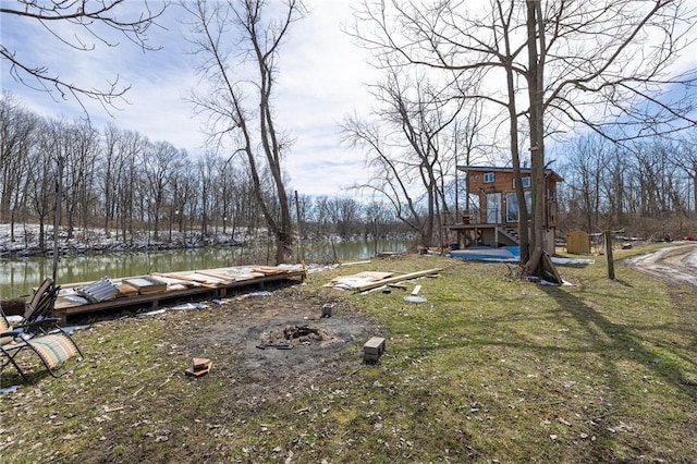 view of yard featuring a dock and a water view