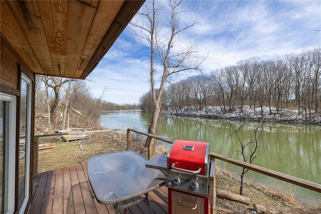 exterior space featuring a grill and a water view