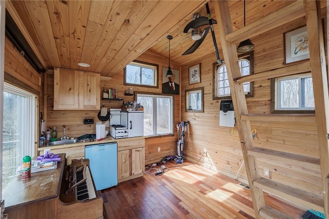 kitchen with a sink, wooden walls, dishwasher, and wooden ceiling