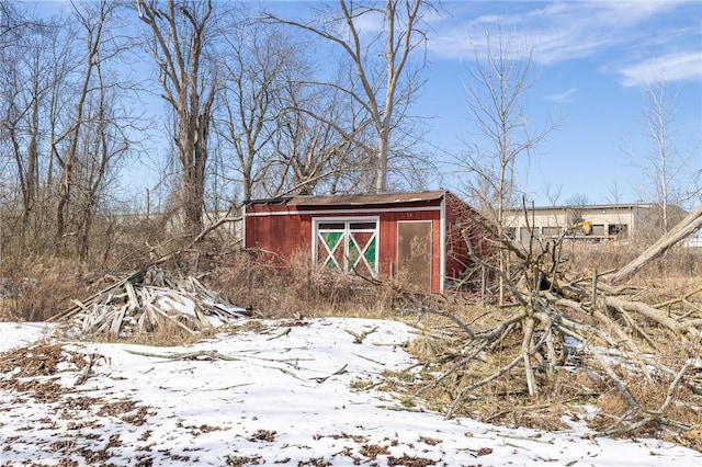 snow covered structure featuring an outdoor structure