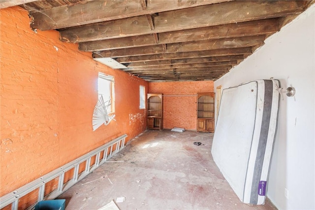 interior space featuring brick wall