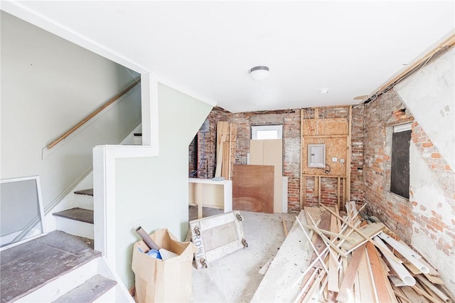 interior space featuring brick wall and stairs