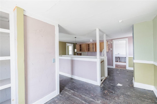 kitchen featuring baseboards and wood finished floors