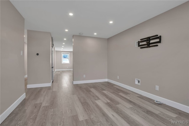 unfurnished room featuring recessed lighting, baseboards, and light wood finished floors