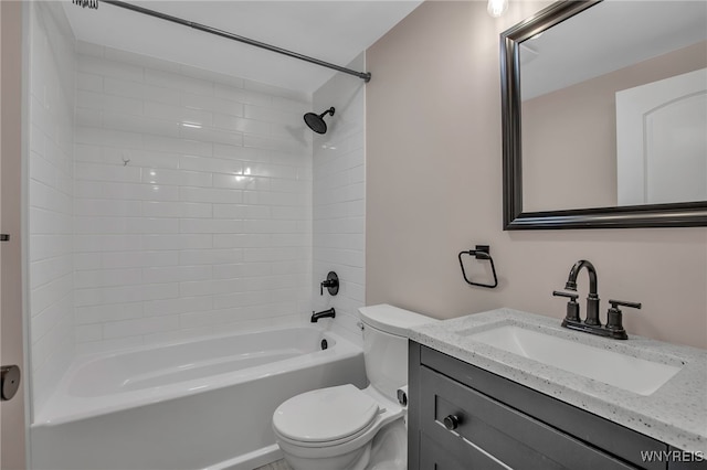 bathroom featuring vanity, toilet, and shower / tub combination