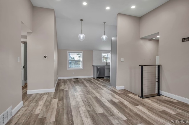 unfurnished living room featuring visible vents, baseboards, recessed lighting, wood finished floors, and high vaulted ceiling