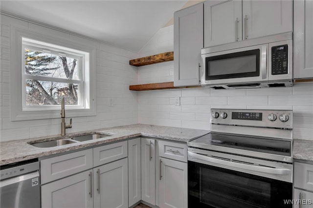 kitchen featuring a sink, open shelves, tasteful backsplash, appliances with stainless steel finishes, and lofted ceiling