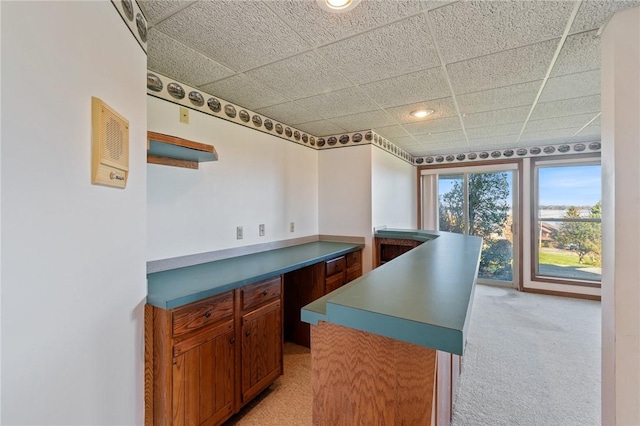 kitchen with light carpet, recessed lighting, and a paneled ceiling