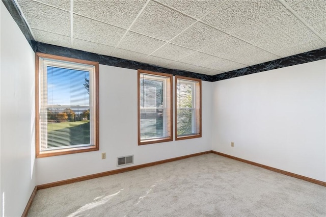 empty room with visible vents, baseboards, and carpet flooring